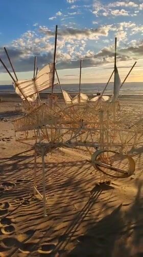 Sunset art installations dot Scheveningen beach at low tide