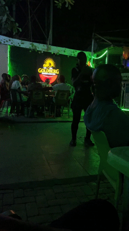 Evening social gathering at outdoor bar in Nyanya, Nigeria