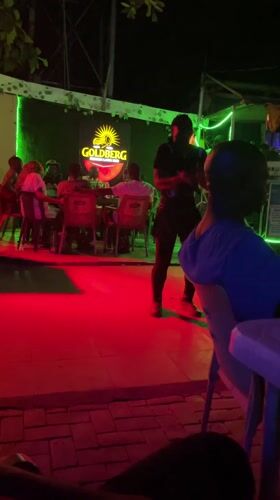 Evening social gathering at outdoor bar in Nyanya, Nigeria