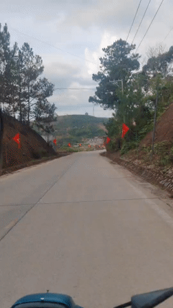 Motorcycle rider travels paved road in Dam Rong, Vietnam