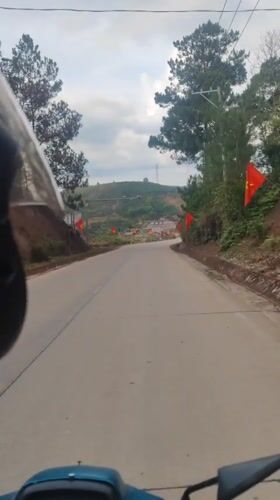 Motorcycle rider travels paved road in Dam Rong, Vietnam