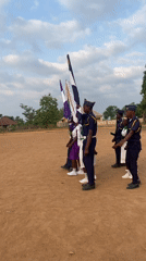 Uniformed group holds ceremonial formation with flags in Andaha