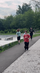 Kids running along a paved path in Divnogorsk