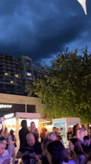 Evening crowd gathers at Odesa outdoor venue as dancing breaks out