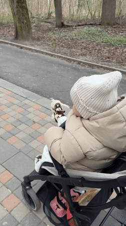 Family outing documented on Klin sidewalks during spring afternoon