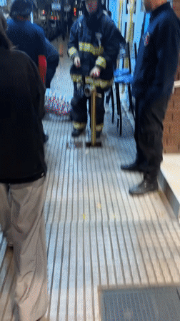 Firefighters operate equipment on Buenos Aires street at night