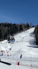 Two men ride ski lifts at resort early morning