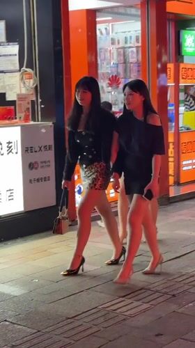 Women gather on Chongqing streets during evening hours