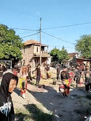 Rural village hosts traditional dance amid agricultural landscapes