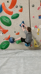 Man practices indoor bouldering in Krasnoyarsk climbing gym