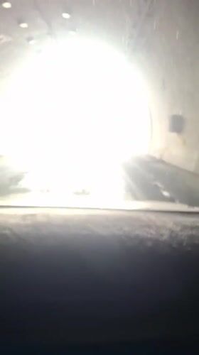 Driver traverses tunnel, emerges into Tajikistan mountain landscape