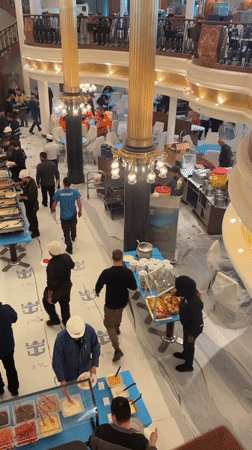 Construction workers gather for buffet lunch in Brest renovation site