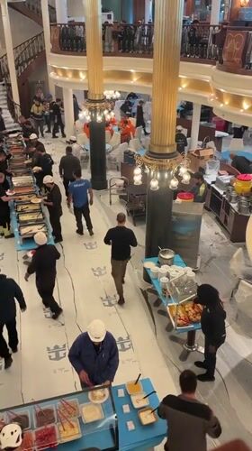 Construction workers gather for buffet lunch in Brest renovation site