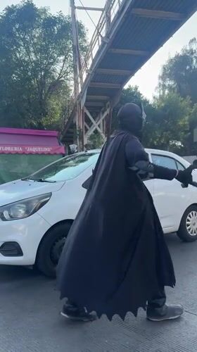 Batman-costumed person directs traffic in Puebla, Mexico
