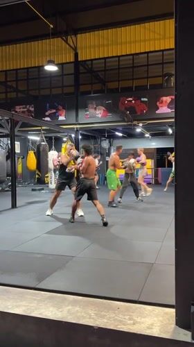 Sparring session and street motorcycles at a Chalong gym