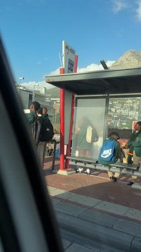 Students gather at Cape Town bus stop near Lion's Head