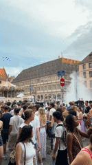 Drum circle and evening crowd at Strasbourg Cathedral square