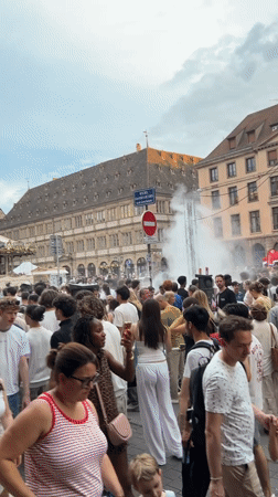 Drum circle and crowds outside Strasbourg Cathedral