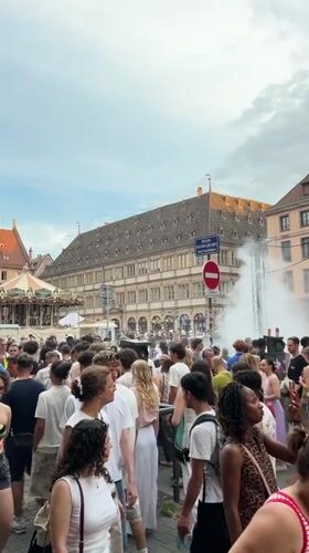Drum circle and evening crowd at Strasbourg Cathedral square