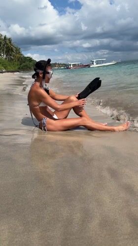 Snorkeler rests on Nusa Penida beach with gear