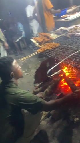 Nighttime street food grilling operation documented in Port Harcourt