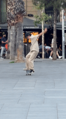 Skateboarders perform tricks in Barcelona plaza during evening session