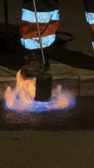 Road worker uses propane torch for asphalt repair in Moscow