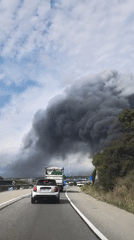 Dark smoke billows along highway in Santa Perpètua de Mogoda