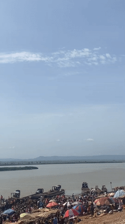 Passenger boat crosses river in Lokoja Nigeria morning