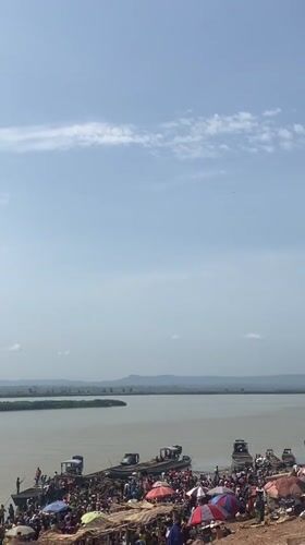 Passenger boat crosses river in Lokoja Nigeria morning