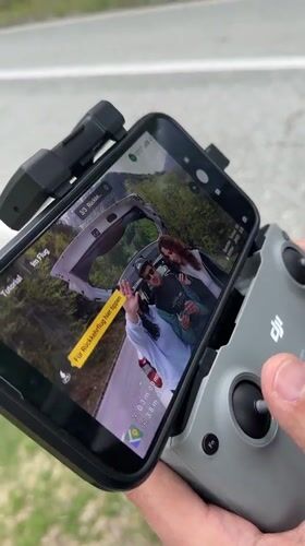 Drone filming session captures woman and car on Montenegro mountain road