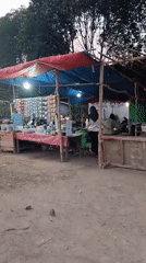 Roadside market stalls at dusk in Pematang Jaya
