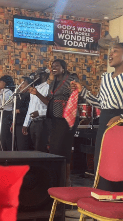 Church service with gospel choir and speaker in Madangala