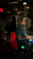 DJ set underway at a Liangjiang nightclub, red and green lights