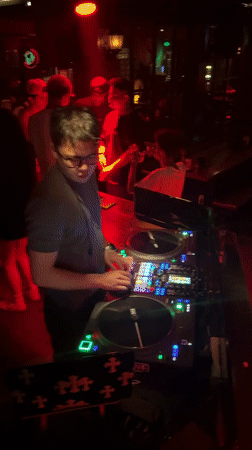 DJ set underway at a Liangjiang nightclub, red and green lights
