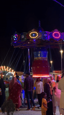 Nighttime carnival operates in Dhaka with illuminated rides, toy stalls