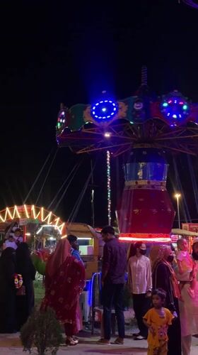 Nighttime carnival operates in Dhaka with illuminated rides, toy stalls