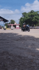 Three motorcycles travel dirt roads in Carora, Venezuela
