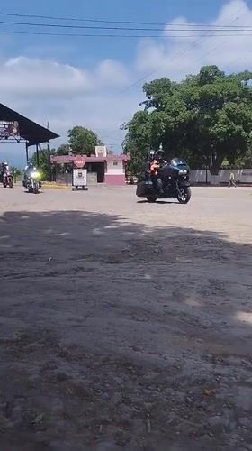 Three motorcycles travel dirt roads in Carora, Venezuela
