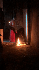 Candlelit gathering filmed in dark urban space