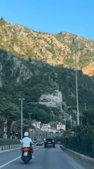 Motorcyclist travels scenic coastal road in Kotor, Montenegro