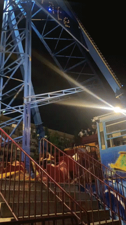 Amusement park night in Makhachkala, rides lit and running