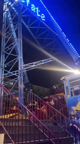 Amusement park night in Makhachkala, rides lit and running