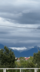 Cloudy mountain landscape with snow-capped peaks observed in Sirius