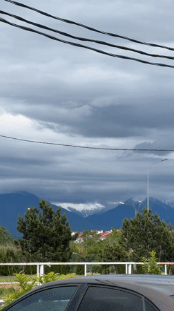 Cloudy mountain landscape with snow-capped peaks observed in Sirius
