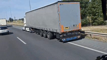 Car trapped under moving semi-truck on Spanish highway