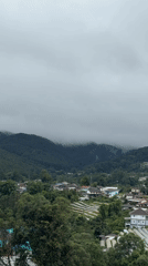 Waterfall and greenhouse farming on a misty Thai hillside