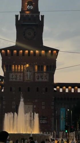 Castello Sforzesco at dusk, vintage tram in motion