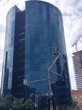 Tallinn street scenes: glass towers, a tow truck, and a historic turret