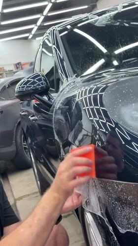 Protective film and window tint going on cars in Krasnoyarsk workshop